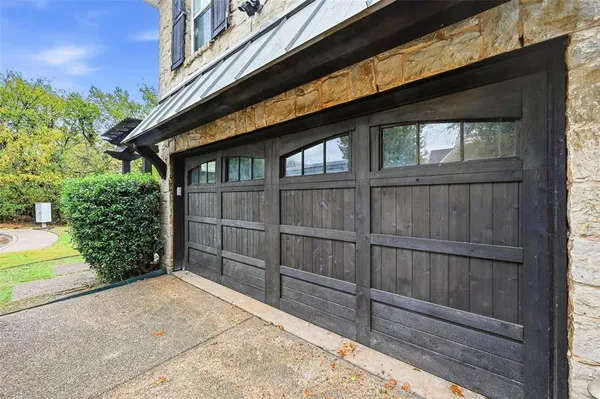 a view of backyard with wooden fence and large windows