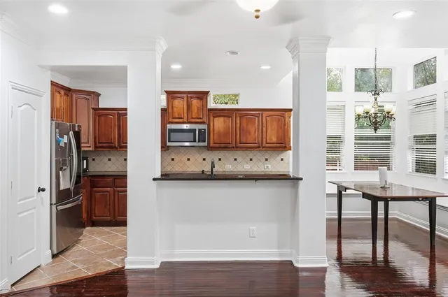 a kitchen with stainless steel appliances granite countertop a refrigerator and stove