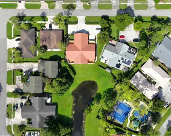 an aerial view of a house with a yard and outdoor seating