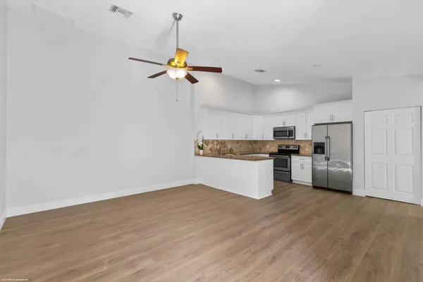 a view of a kitchen with wooden floor