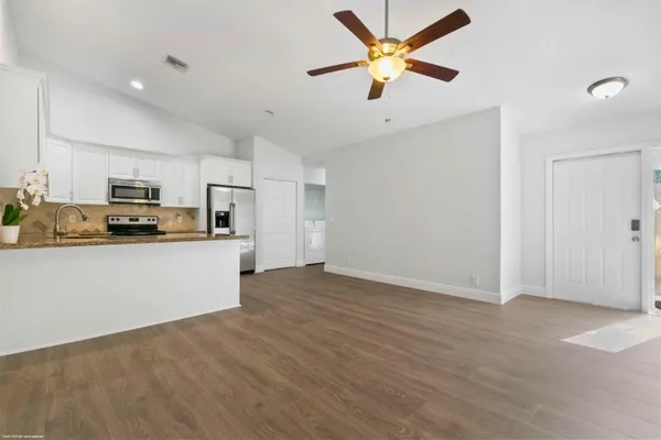 a view of kitchen with microwave and cabinets