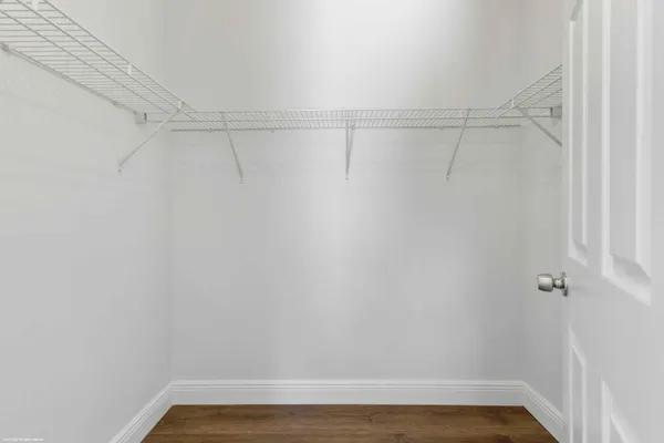 a view of a room with wooden floor