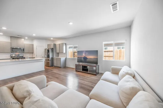 a living room with furniture fireplace and flat screen tv