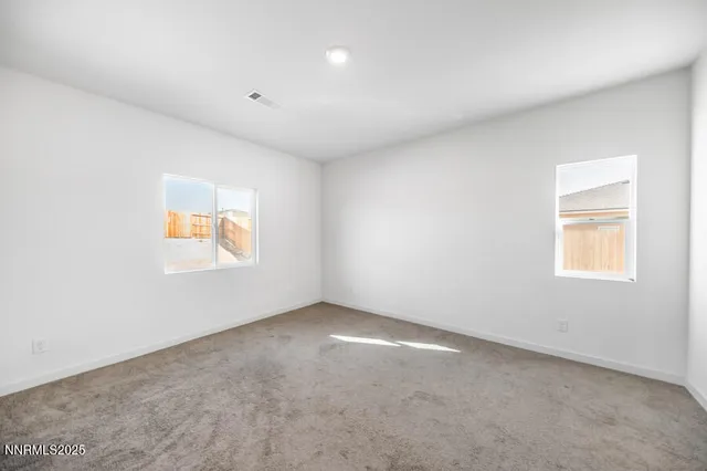 an empty room with entrance and windows