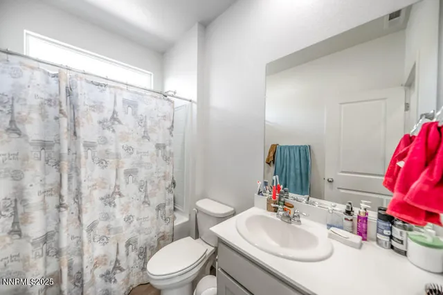 a view of a dry yard with wooden fence
