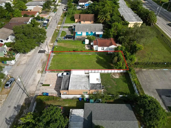 an aerial view of multiple houses with yard