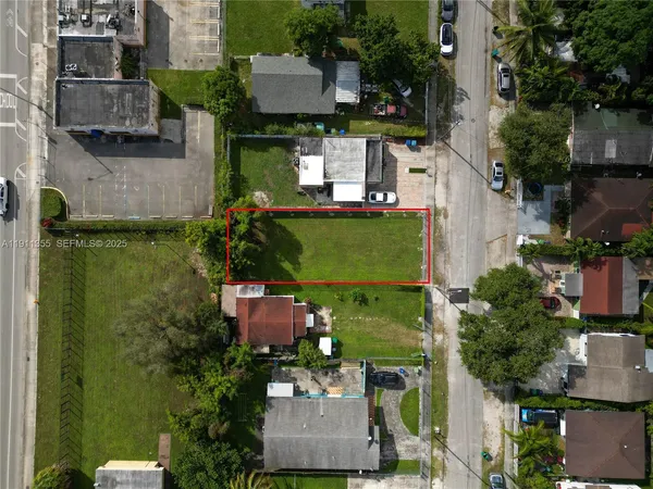 an aerial view of a house with a yard and outdoor seating