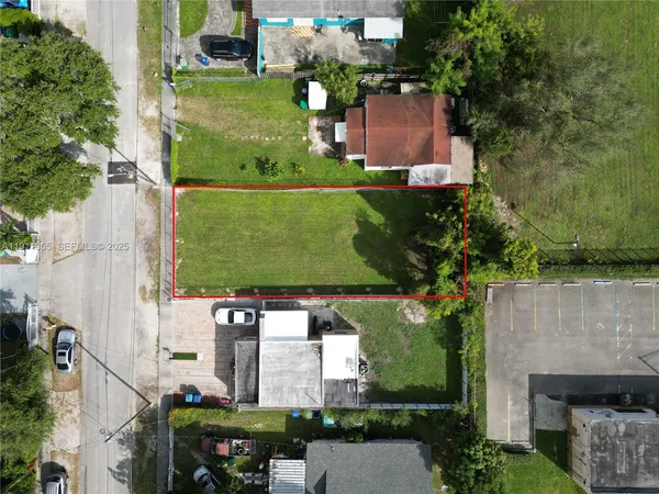 an aerial view of a house with outdoor space pool seating area and yard