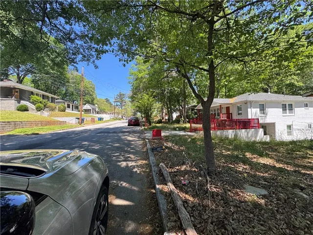 a view of a house with backyard and sitting area