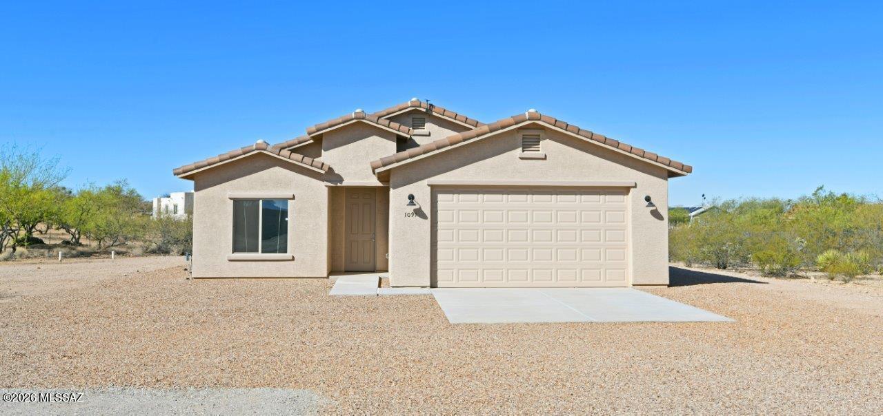 1091 North Vail View Road Vail, AZ 85641 - Photo 1 of 43 a front view of a house with a yard and garage