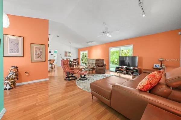 a dining room with furniture and wooden floor