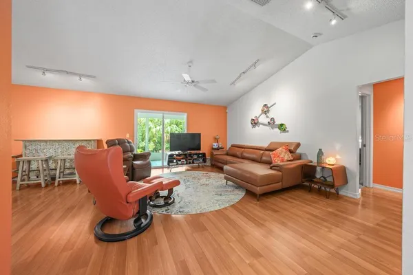 a dining room with furniture and wooden floor