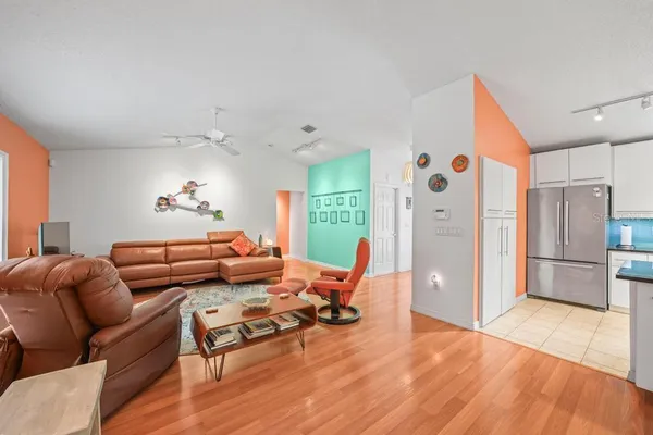 a kitchen with a table chairs and white cabinets