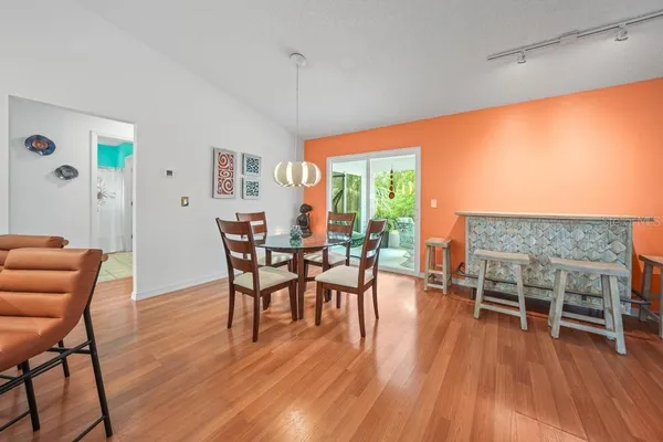 a kitchen with stainless steel appliances granite countertop a stove top oven a sink dishwasher and a fireplace with wooden floor