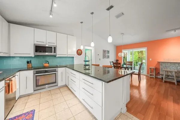 a spacious bedroom with a bed and a chandelier