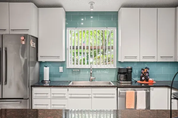 a spacious bedroom with a bed and a large window