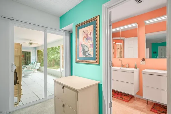 a bedroom with a bed and a chandelier fan