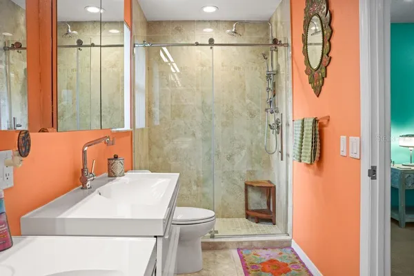 a bathroom with a sink mirror vanity and toilet