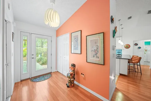 a living room with furniture a rug and a large window