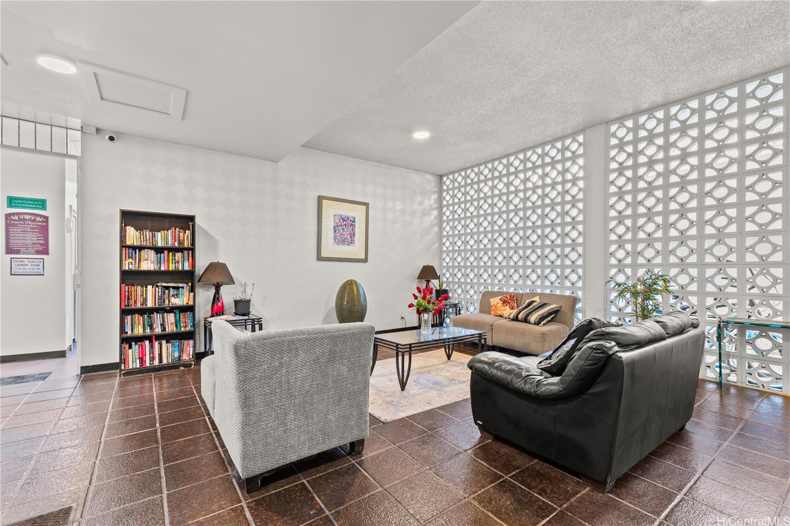 1069 Spencer Street, Unit 101 Honolulu, HI 96822 - Photo 17 of 19 a living room with furniture and a book shelf