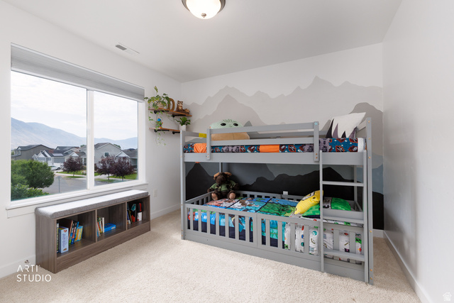 1654 South 730 West Provo, UT 84601 - Photo 15 of 33 Carpeted room featuring a large window, mountain mural accent wall, built-in shelving, and a flush mount ceiling light fixture