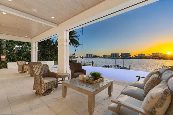 a roof deck with couches and city view