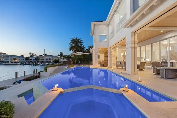 a kitchen with stainless steel appliances kitchen island granite countertop a sink and cabinets