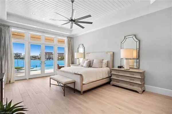 a bedroom with a bed and large window