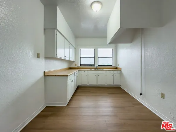 a view of a kitchen with a sink cabinets and a window