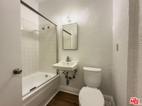 a bathroom with a sink a toilet and bathtub
