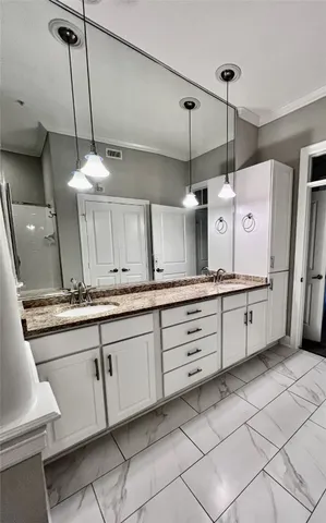 a kitchen with granite countertop white cabinets and white appliances