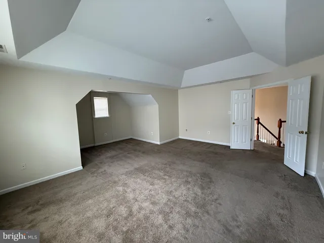 an empty room with windows and entrance