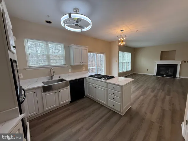 a view of a room with stairs and wooden floor