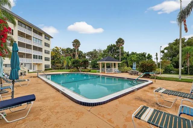 a view of a white house with a yard and plants