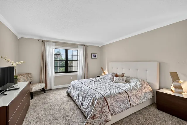 a bedroom with a bed and a flat screen television