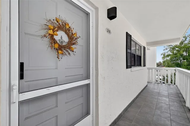 a hallway with painting on the wall and a chandelier