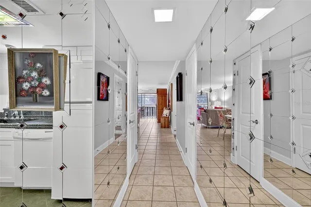 a kitchen with white cabinets and refrigerator