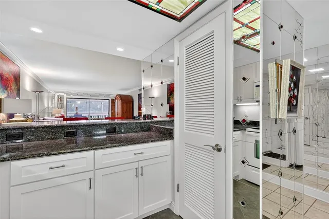 a kitchen with stainless steel appliances granite countertop a sink a stove and cabinets