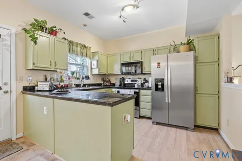 a kitchen with a refrigerator a sink and dishwasher