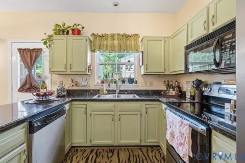 a kitchen with a sink stove top oven and cabinets