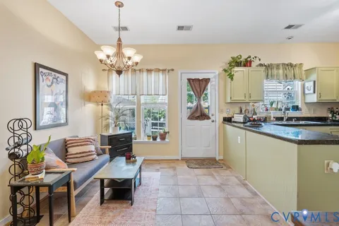 a living room with furniture and a chandelier