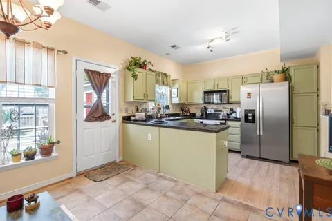 a kitchen with granite countertop a refrigerator and a sink