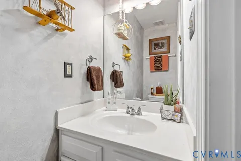 a bathroom with a sink vanity and a mirror