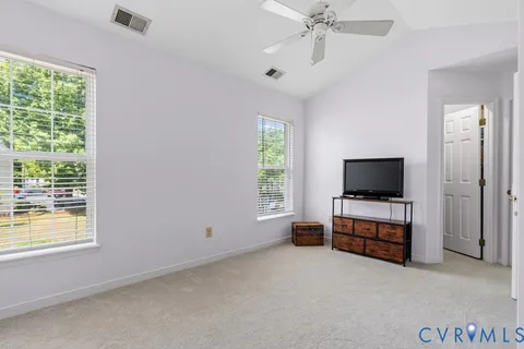 a view of a livingroom with furniture and a flat screen tv