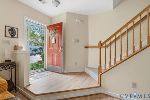 a view of an entryway with wooden floor and livingroom view