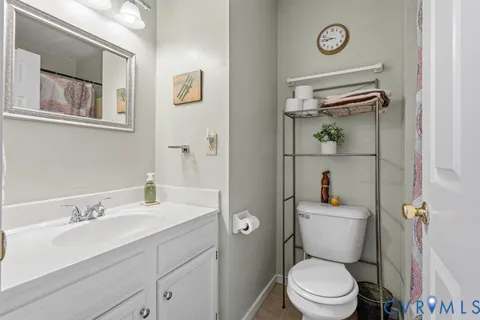 a bathroom with a sink toilet and vanity