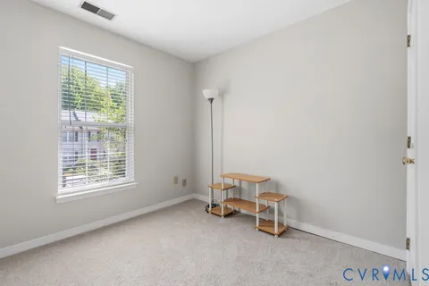 a view of a room with gym equipment and windows