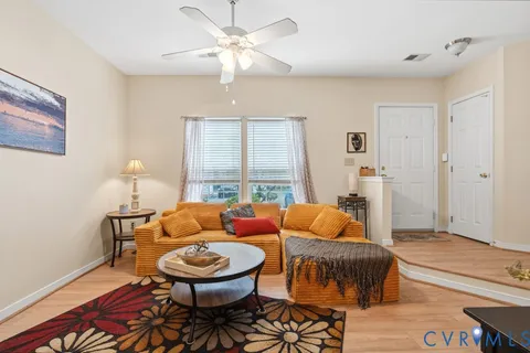 a bedroom with furniture and wooden floor