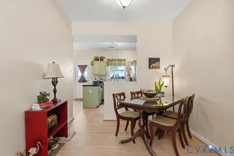 a dining room with furniture and wooden floor