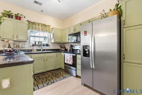 a kitchen with a refrigerator and a sink